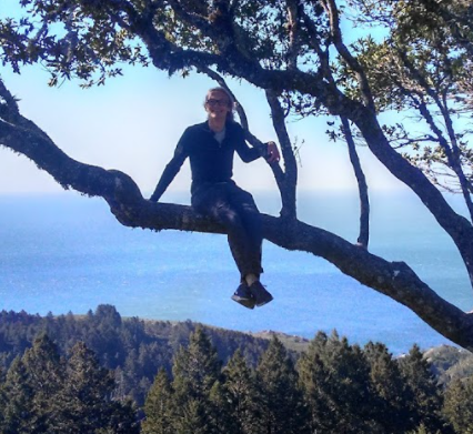 Photo of Milton Stookey sitting on a tree branch