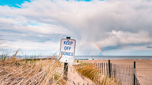 Keep Of Dunes signage at a beach