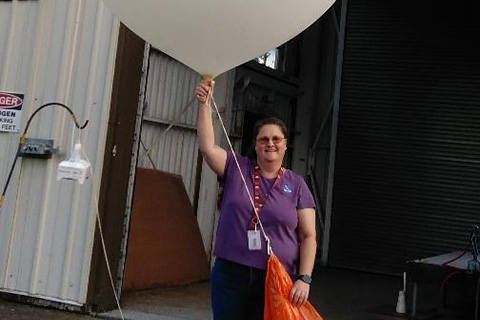 Faith Borden holding a weather balloon