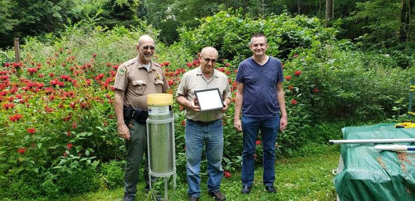 Chris Stachelski (right) presents an award to the Newark Water District for 75 years of observations at their stations