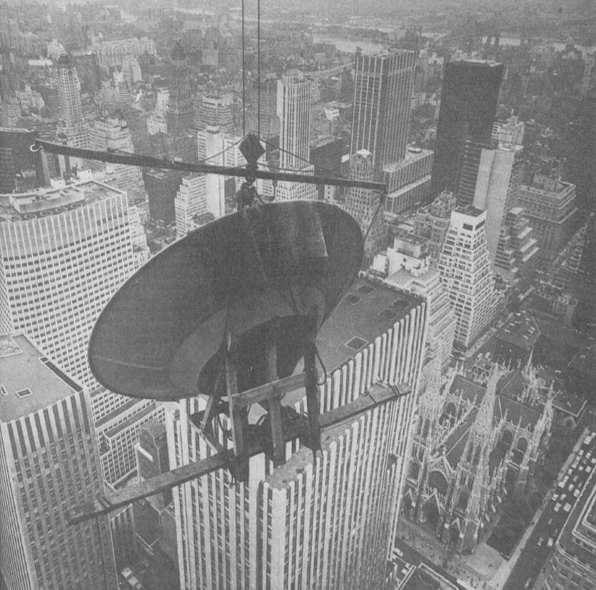 A crane hoists the radar dish of the WSR-57 radar to the 70th floor of the RCA Building in midtown Manhattan, on June 13, 1960. 