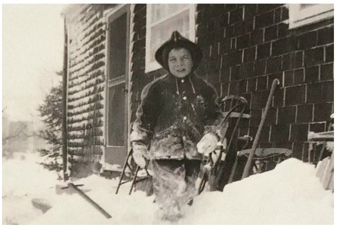 Black and white photo: Dr. Uccellini as a kid, playing in the snow