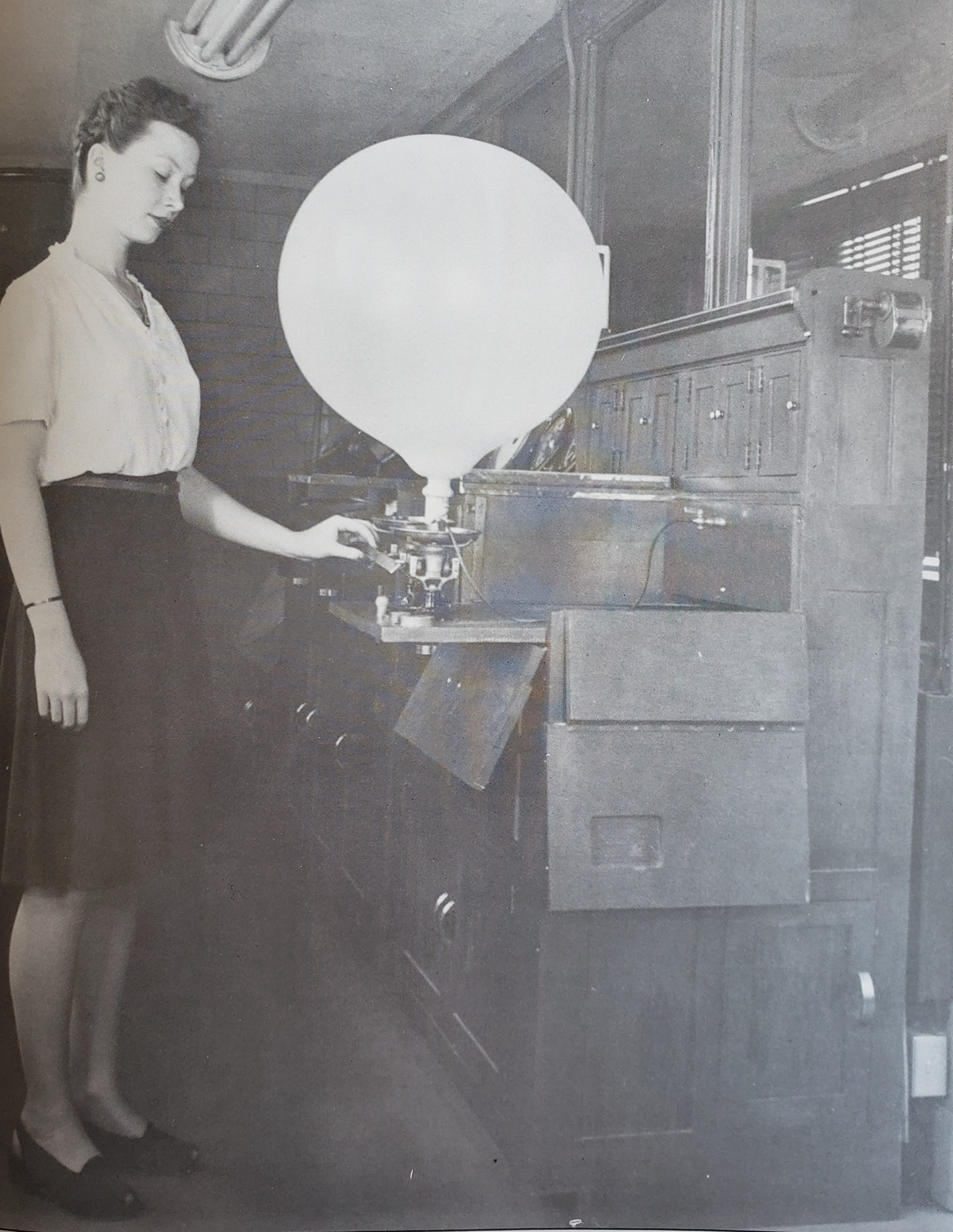 Grace D. Harding inflating a pilot balloon for observation.