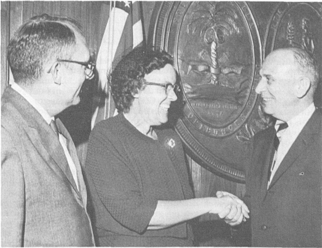 Hazel Tatro is congratulated by South Carolina Gov. Donald Russell (right), as Columbia (S.C.) MIC John Purvis watches. 